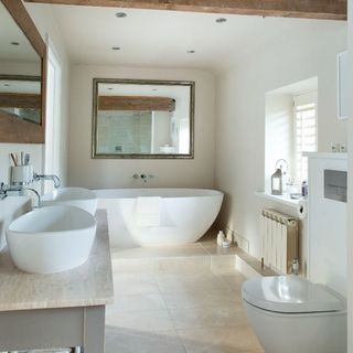 Rustic bathroom with large mirror and two sinks on the vanity