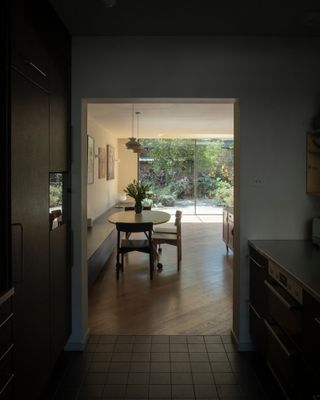 The galley kitchen leads to the L-shaped living space with the garden beyond