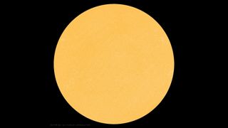 a spotless yellow orb on a black background