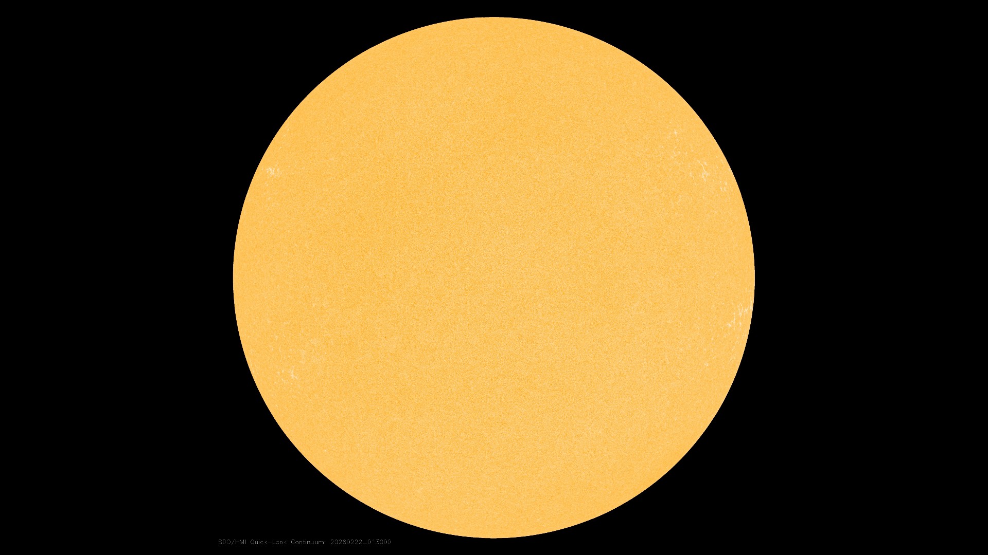 a spotless yellow orb on a black background