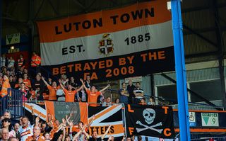 A banner inside Kenilworth Road which reads 'Luton Town EST 1885, Betrayed by the FA 2008' during the Skrill Conference Premier match between Luton Town and Forest Green at Kenilworth Road on April 21, 2014 in Luton, England. (Photo by Marc Atkins/Mark Leech/Getty Images)