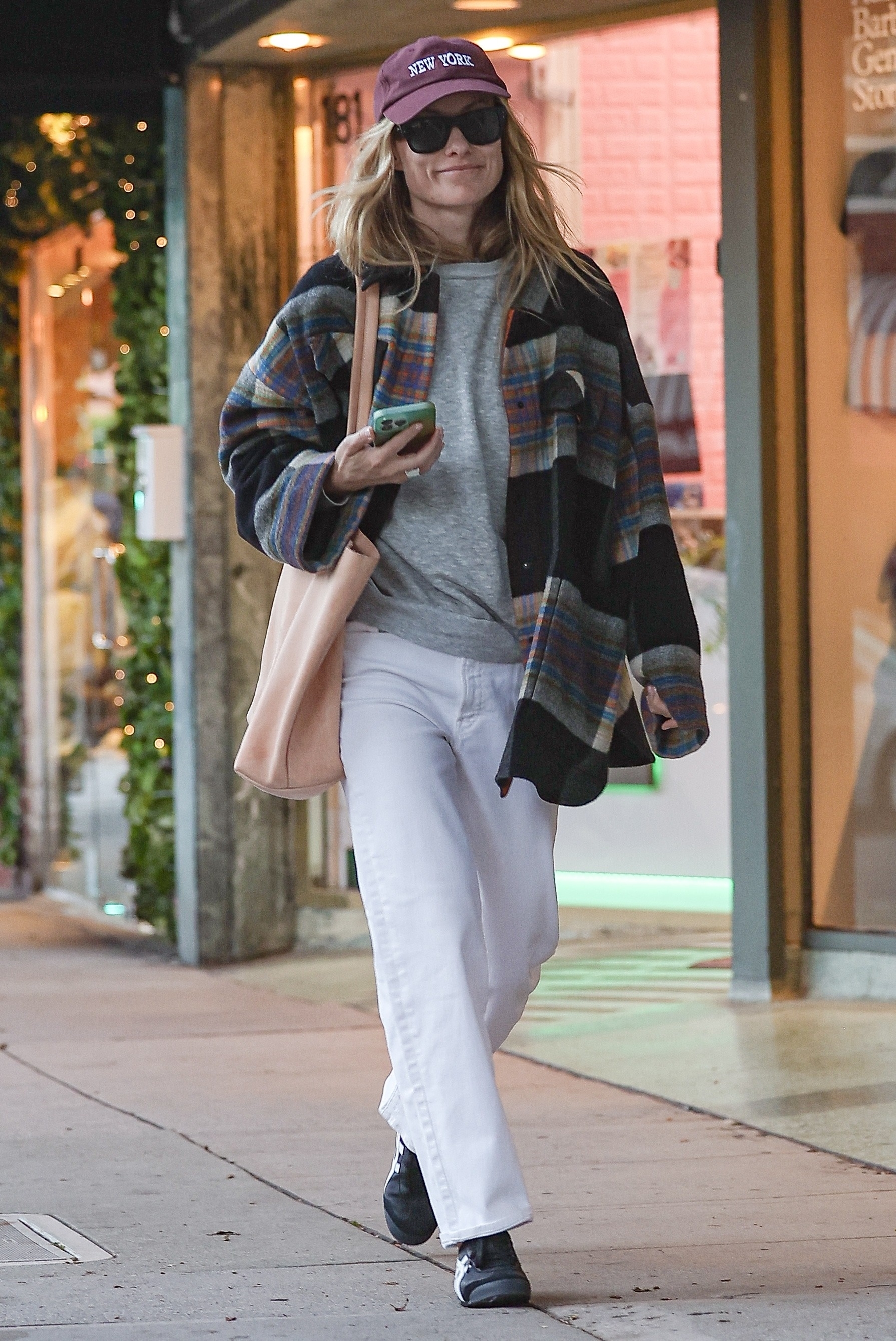 Olivia Wilde wore her white jeans outfit with Onitsuka Tiger sneakers on April 6
