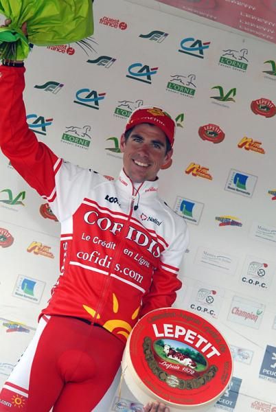 S&eacute;bastien Minard (Cofidis) on the podium with his huge wheel of cheese.