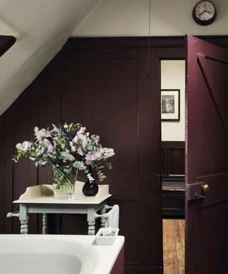 aubergine eggplant bathroom with white bath, side table, shiplap walls, shelving, towel storage, Farrow & Ball