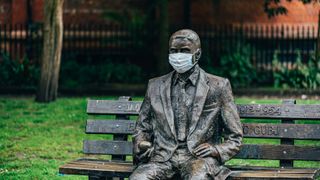 Alan Turing memorial statue, located in Sackville Park, Manchester, wearing a face mask