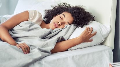 Shot of a young woman sleeping peacefully in her bed.