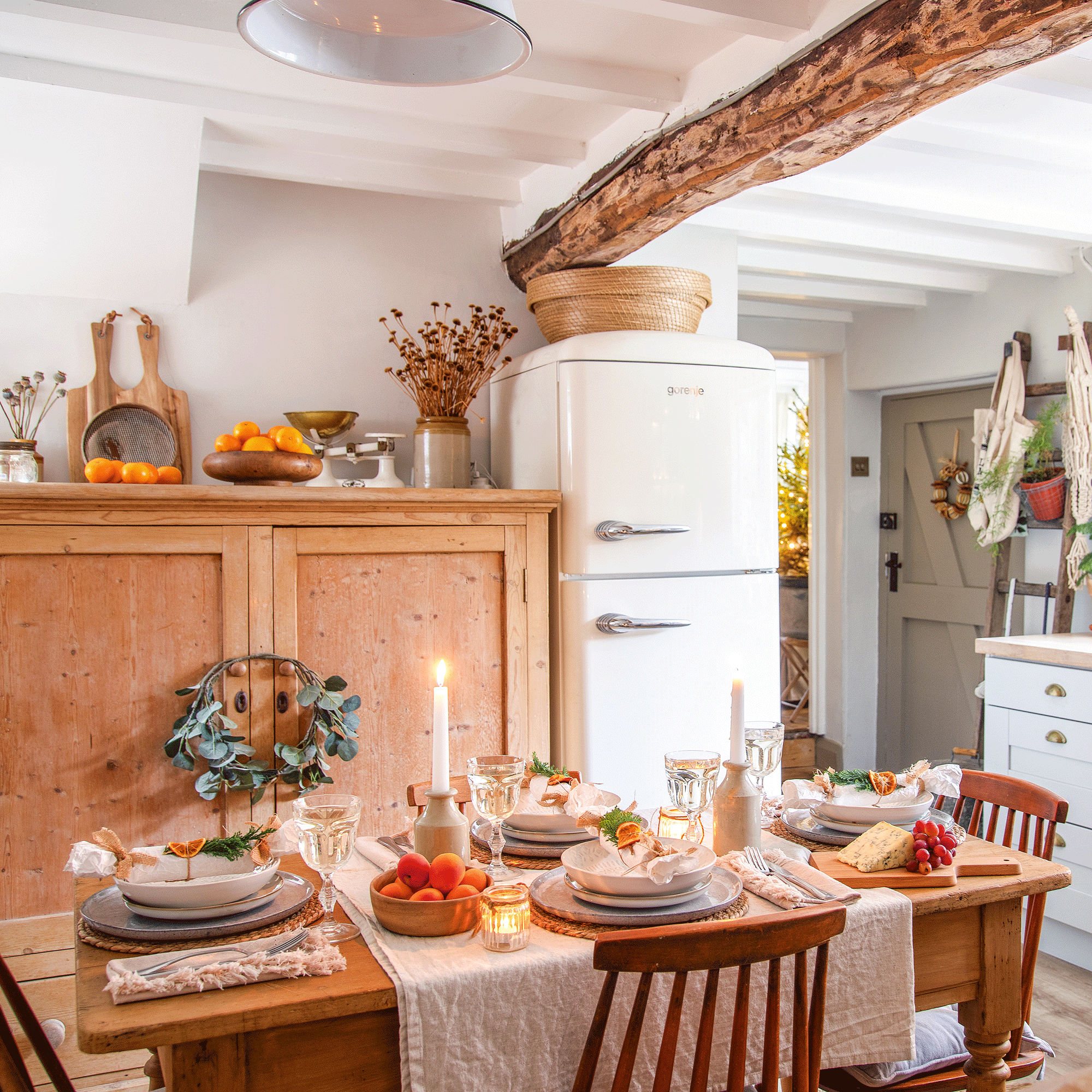a kitchen diner with a retro fridge freezer and a dining table set for Christmas dinner