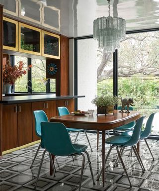 Modern dining room space with round table a wooden console hosting seasonal foliage in a vase