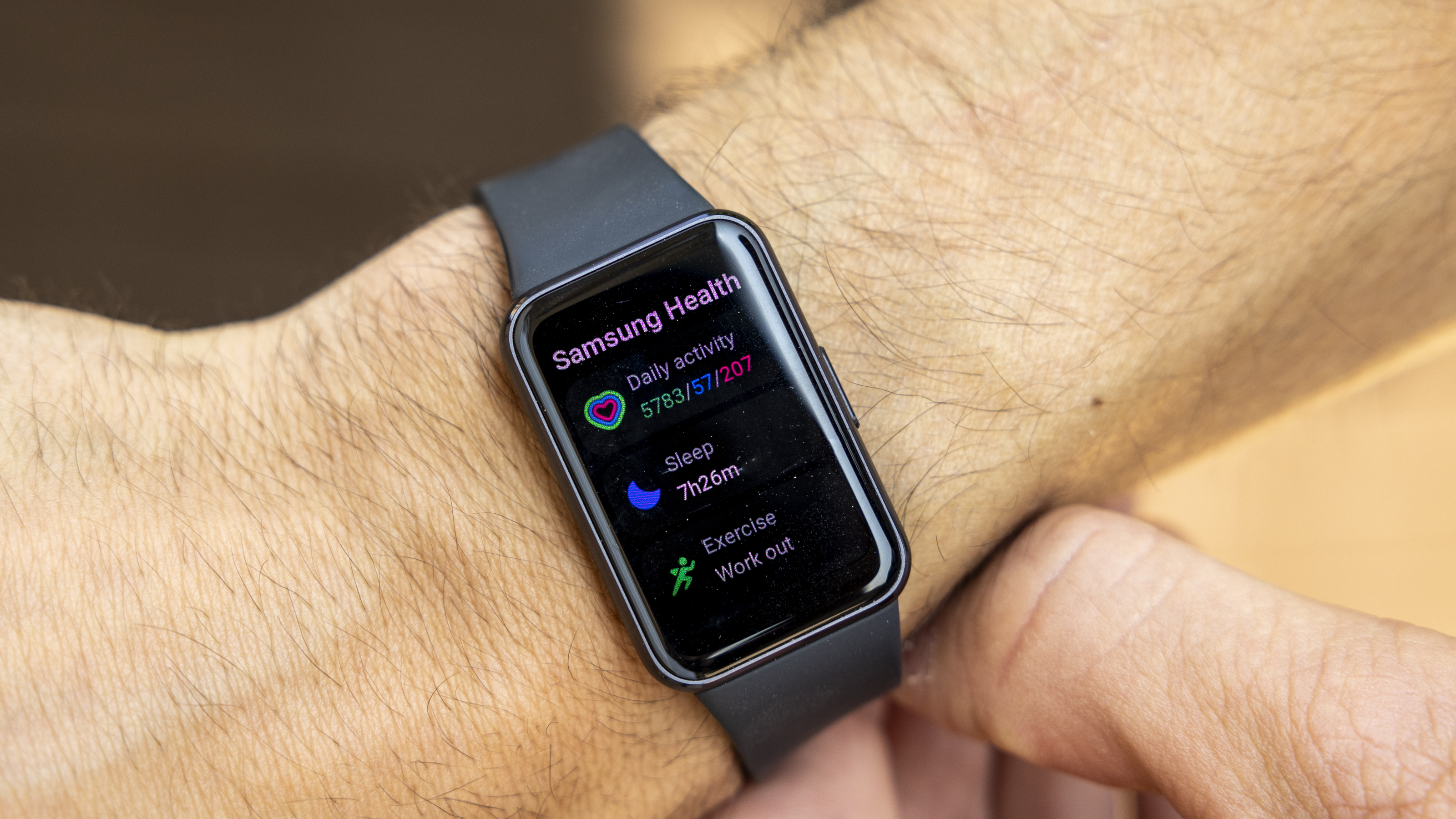 The Samsung Galaxy Fit 3 watch in grey worn on a female wrist