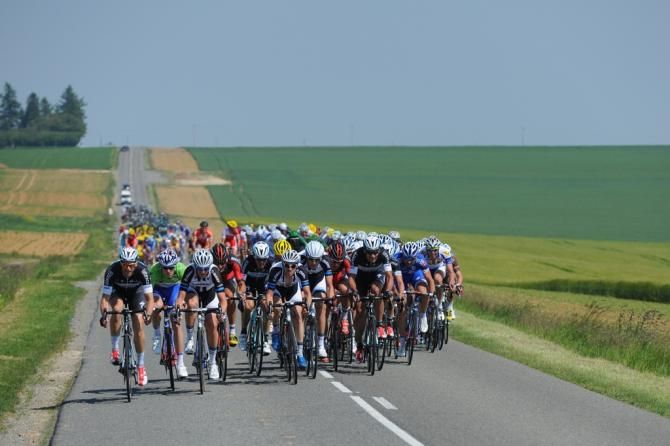 The peloton passes through the green countryside