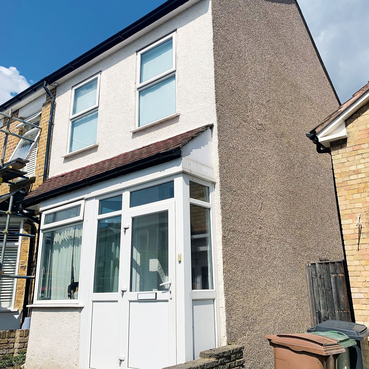 The front elevation of a pebble-dashed terraced house