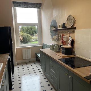 painted kitchen with shelf and tiled floor