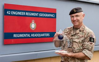 Lt Col Alex harris of the 42 Engineering Regiment holding an award