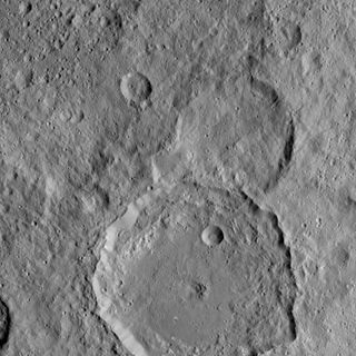 NASA's Dawn Spacecraft took this image of Gaue crater, the large crater on the bottom, on Ceres. Gaue is a Germanic goddess to whom offerings are made in harvesting rye. The image was taken on Aug. 19, 2015.