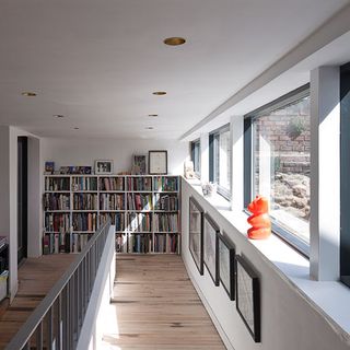 white and oak floor hallway bookshelf