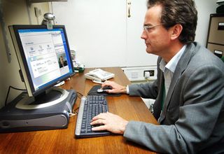 IT professional in front of a computer screen