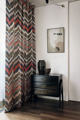 zig zag patterned curtain in room with wooden floor