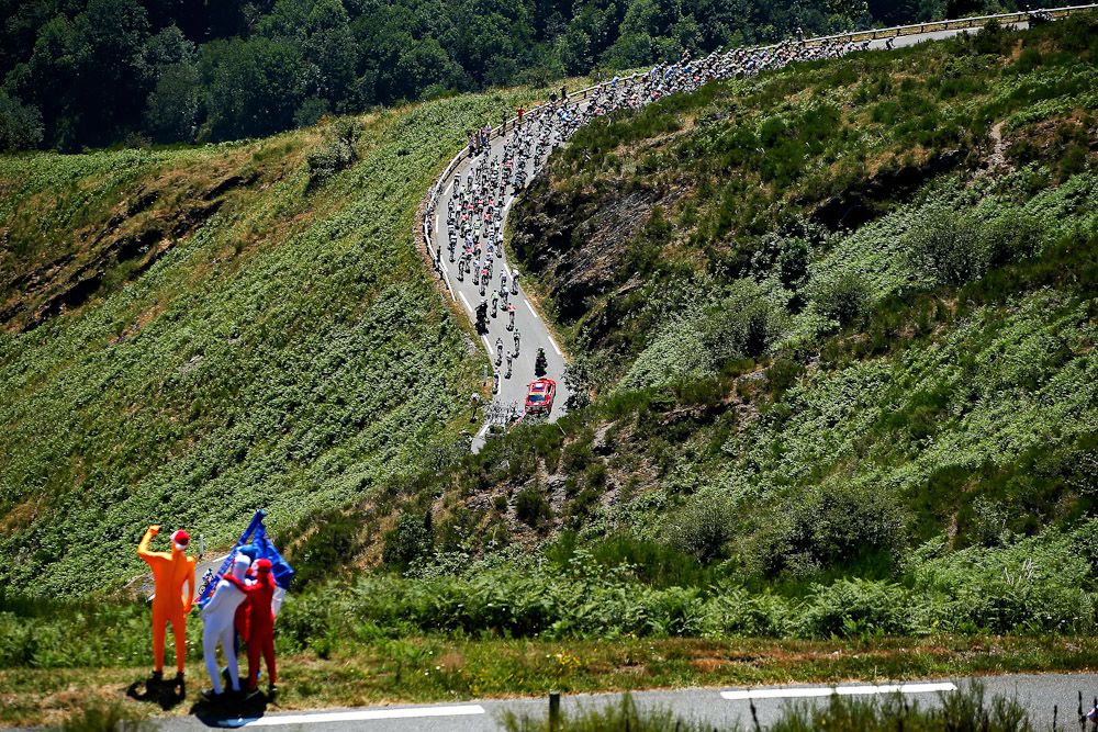 Spectators wait for the peloton to arrive.