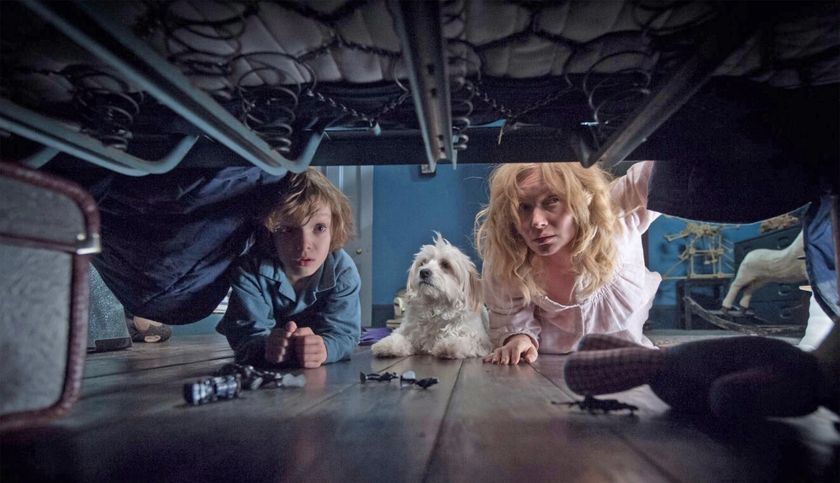 (From left to right) Noah Wiseman as Samuel Vanek and Essie Davis as Amelia Vanek looking under a bed in The Babadook