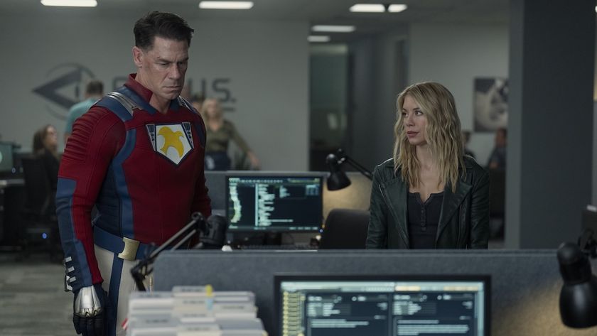 Peacemaker and Emilia Harcourt looking down at a desk in Earth-X&#039;s ARGUS headquarters.