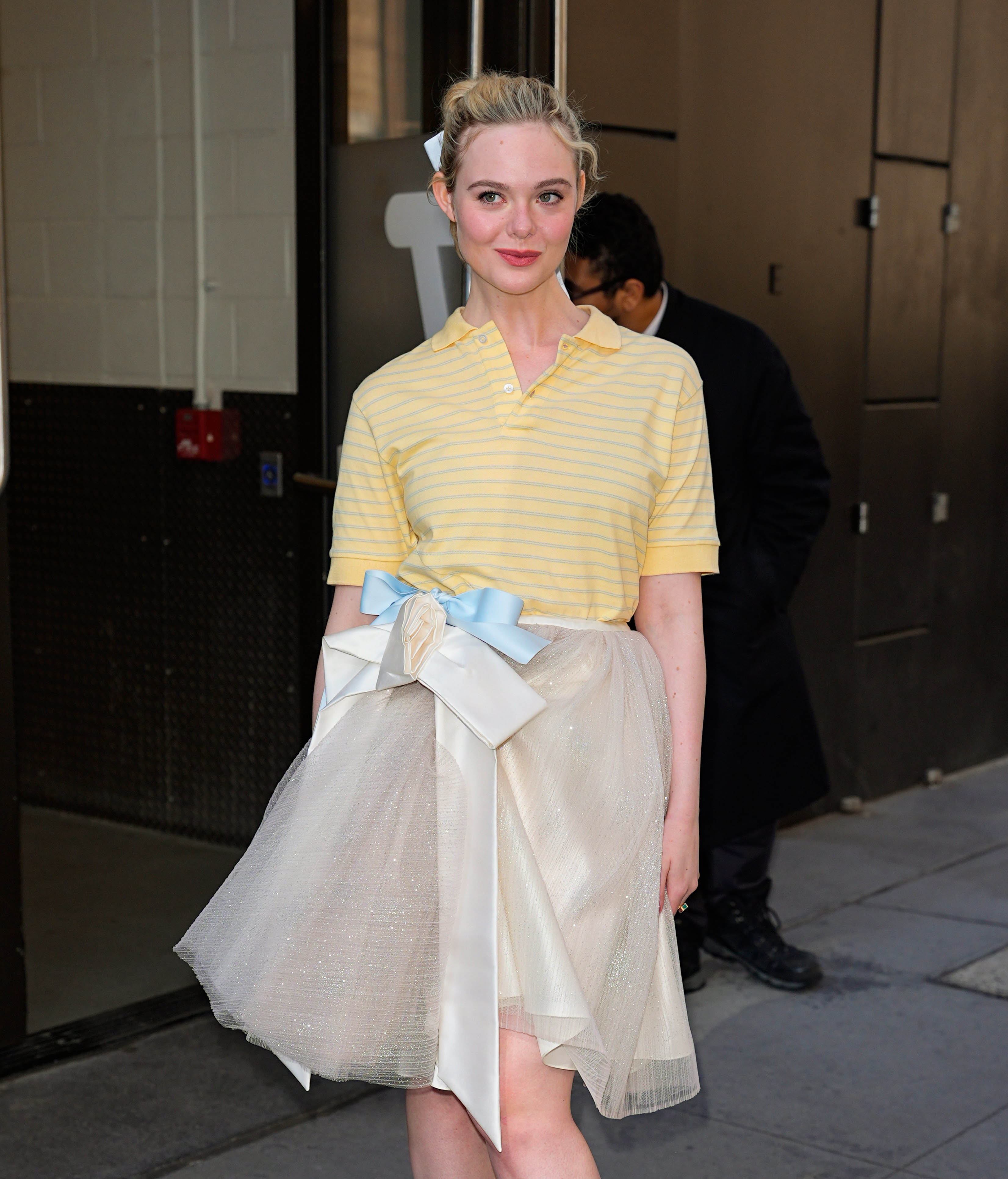 Elle Fanning promoted 'Margo's Got Money Troubles' in a butter yellow polo shirt, a tutu skirt, and the doll heels trends