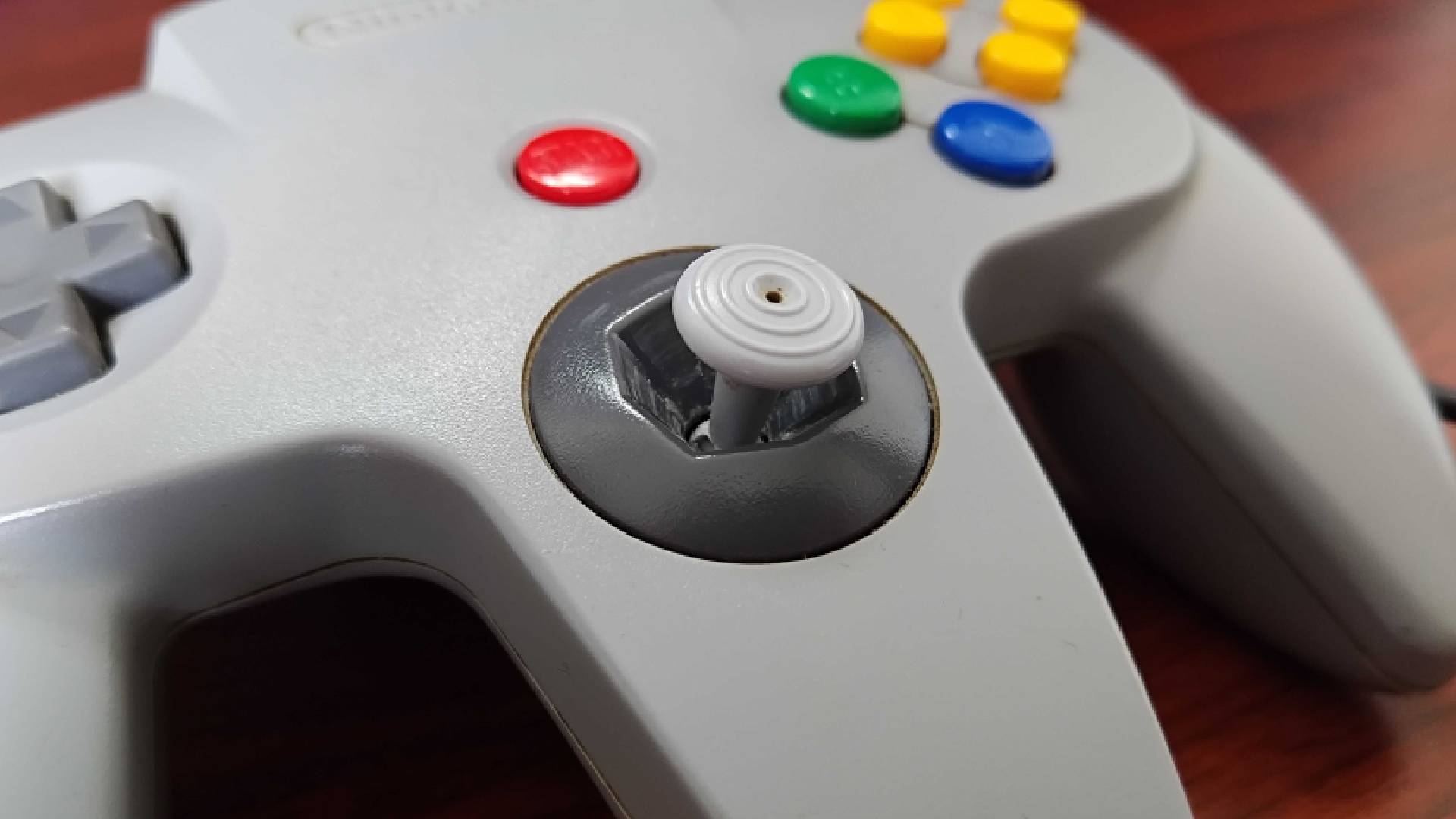 Close up of N64 controller before cleaning with original thumbstick. 