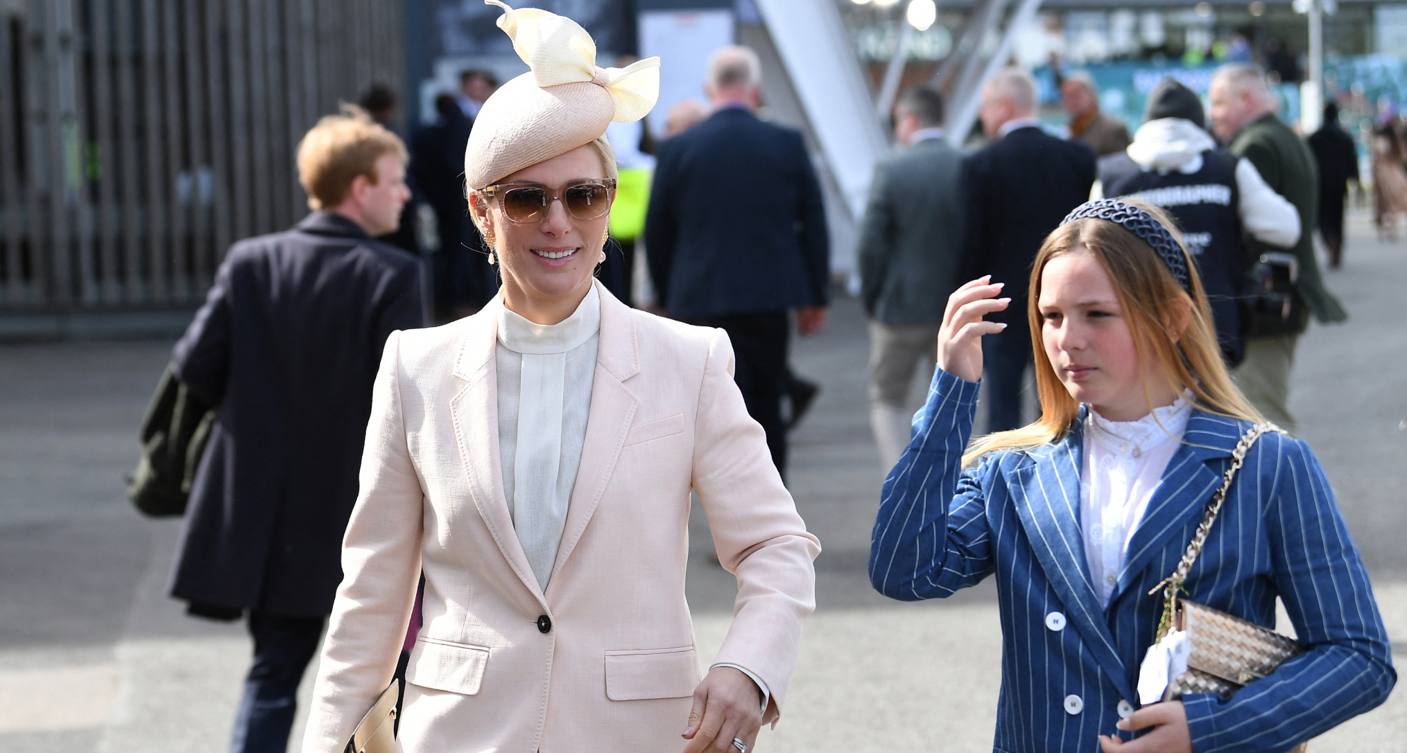 Zara and Mia Tindall walking next to each other in trouser suits