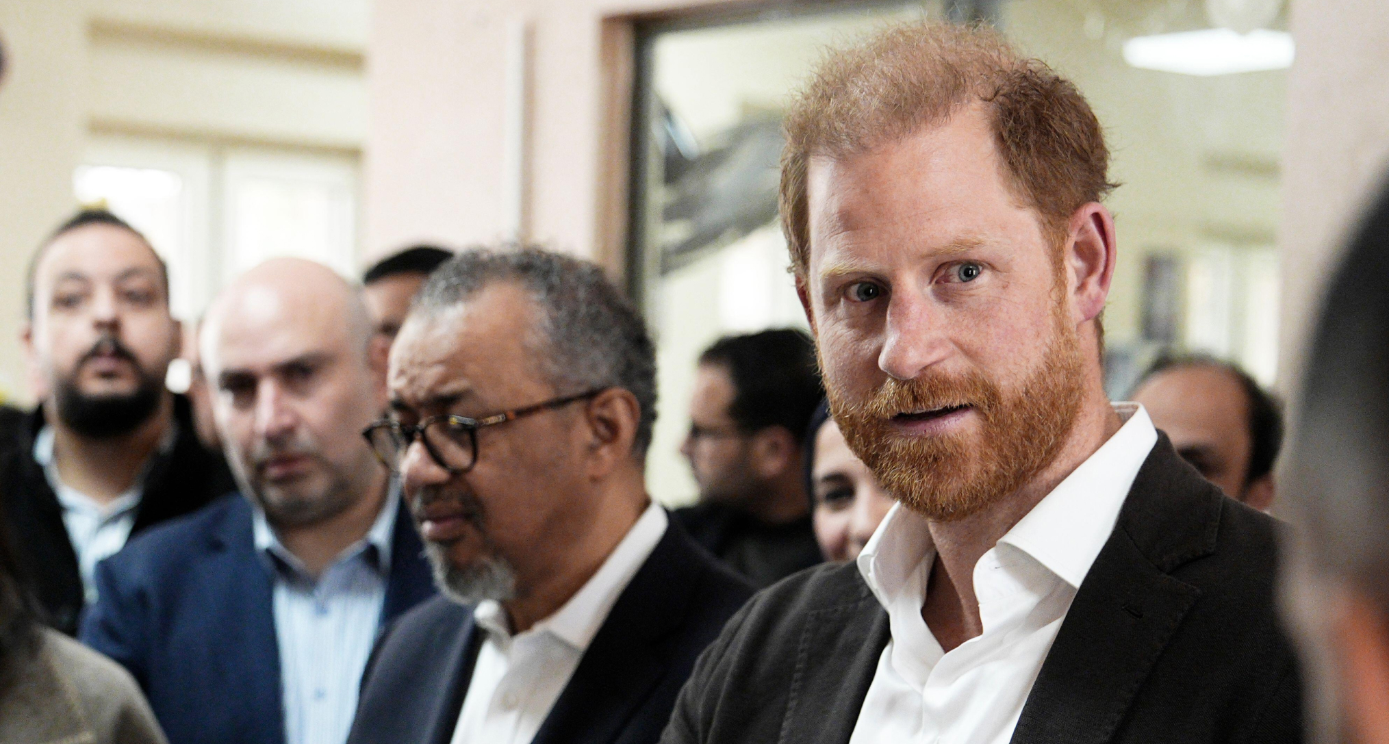 Prince Harry wearing a white shirt and black blazer