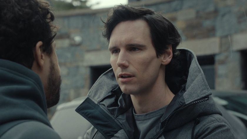 Cory Michael Smith looking at Ramy Youssef in Mountainhead. 