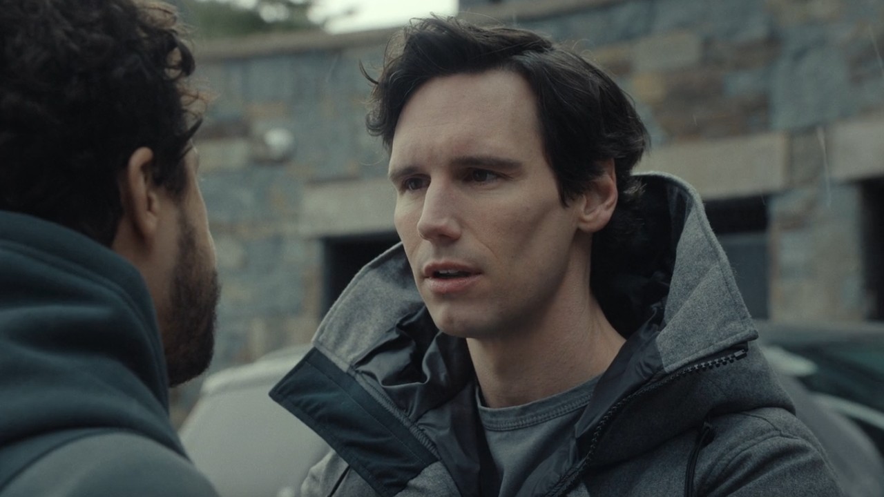 Cory Michael Smith looking at Ramy Youssef in Mountainhead.
