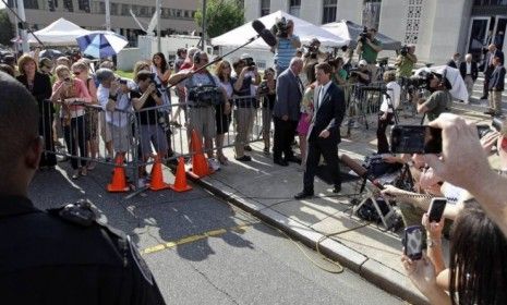 John Edwards leaves a North Carolina courthouse after his campaign finance fraud case ended in a mistrial on Thursday.