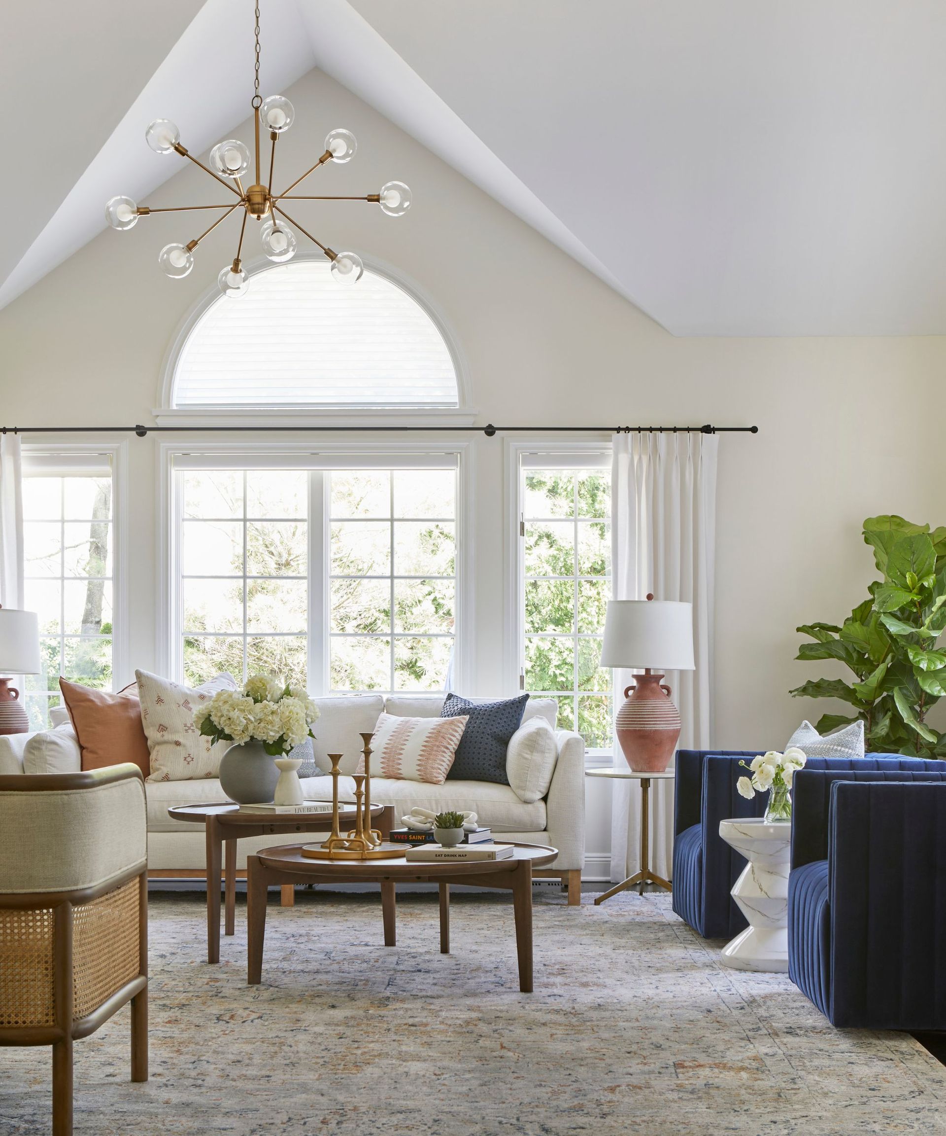 light and airy living room with neutral color scheme, high sloped ceiling
