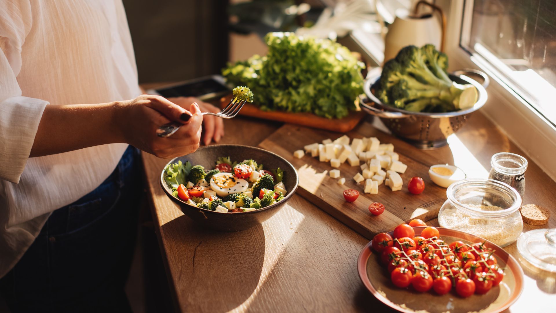 Woman making salad with vegetables