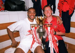 LONDON, ENGLAND - MAY 15: Thierry Henry and Ray Parlour of Arsenal with the Premier League trophy after the match between Arsenal and Leicester City in the Premier League at Highbury on May 15, 2004 in London, England. (Photo by Stuart MacFarlane/Arsenal FC via Getty Images)