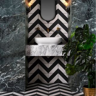 bathroom with chevron tiled walls and black and white pattern flooring