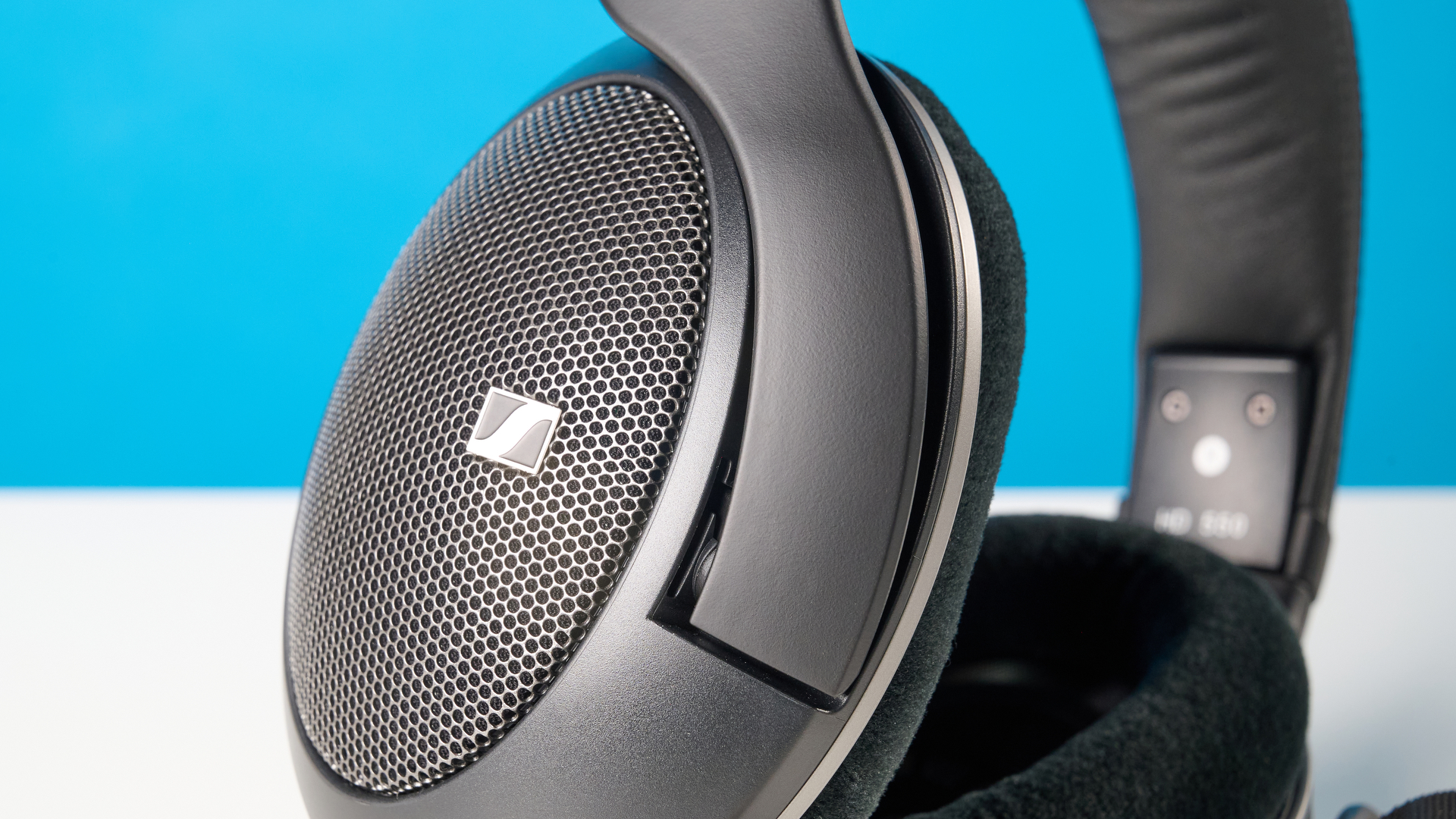The Sennheiser HD 550 headphones on a stone surface with a blue background