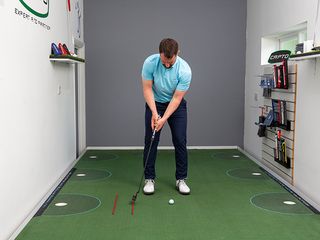 James Jankowski demonstrating a stroke length putting drill using alignment sticks