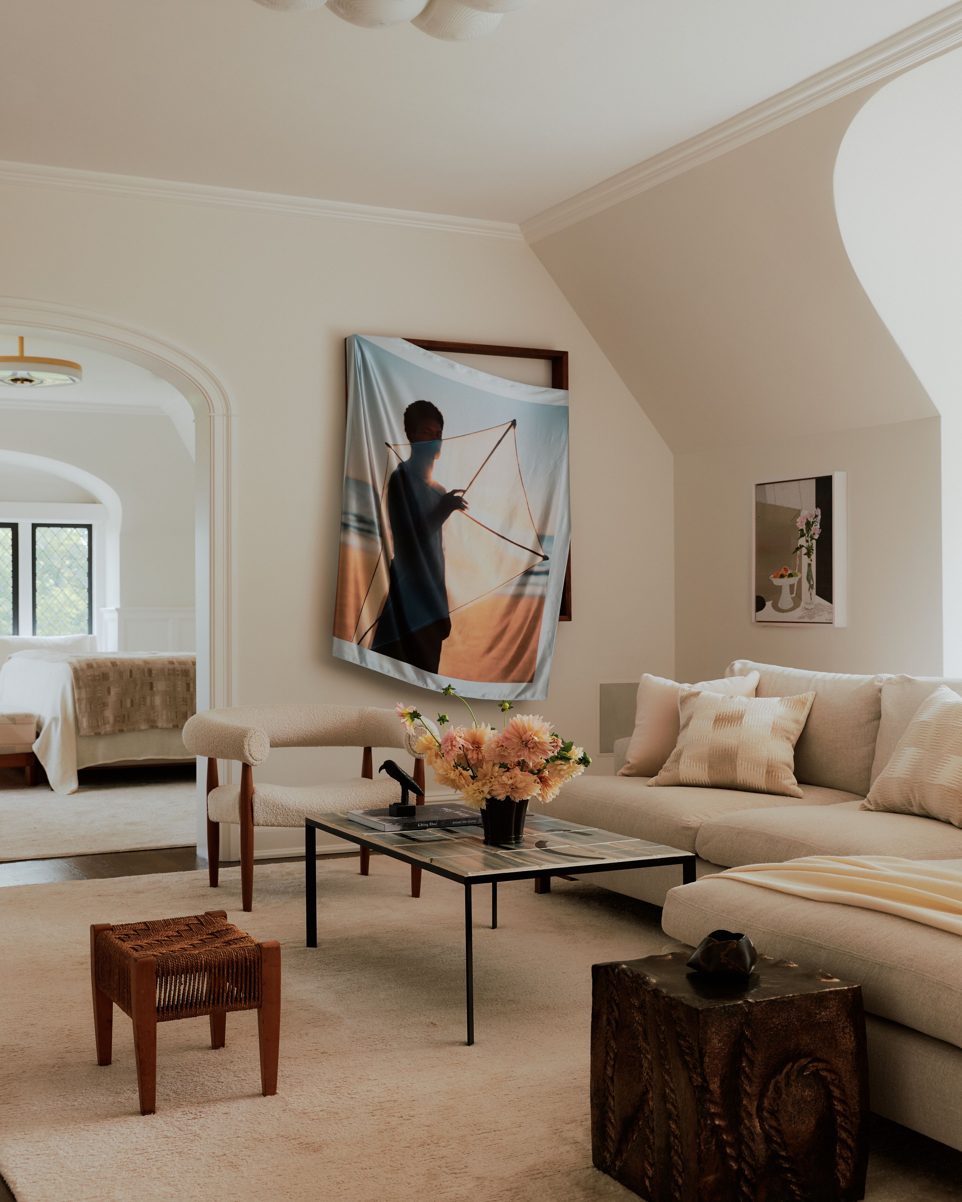 Sun-lit interior of a palatial residence wooden windows, white-washed walls, and artful decor.