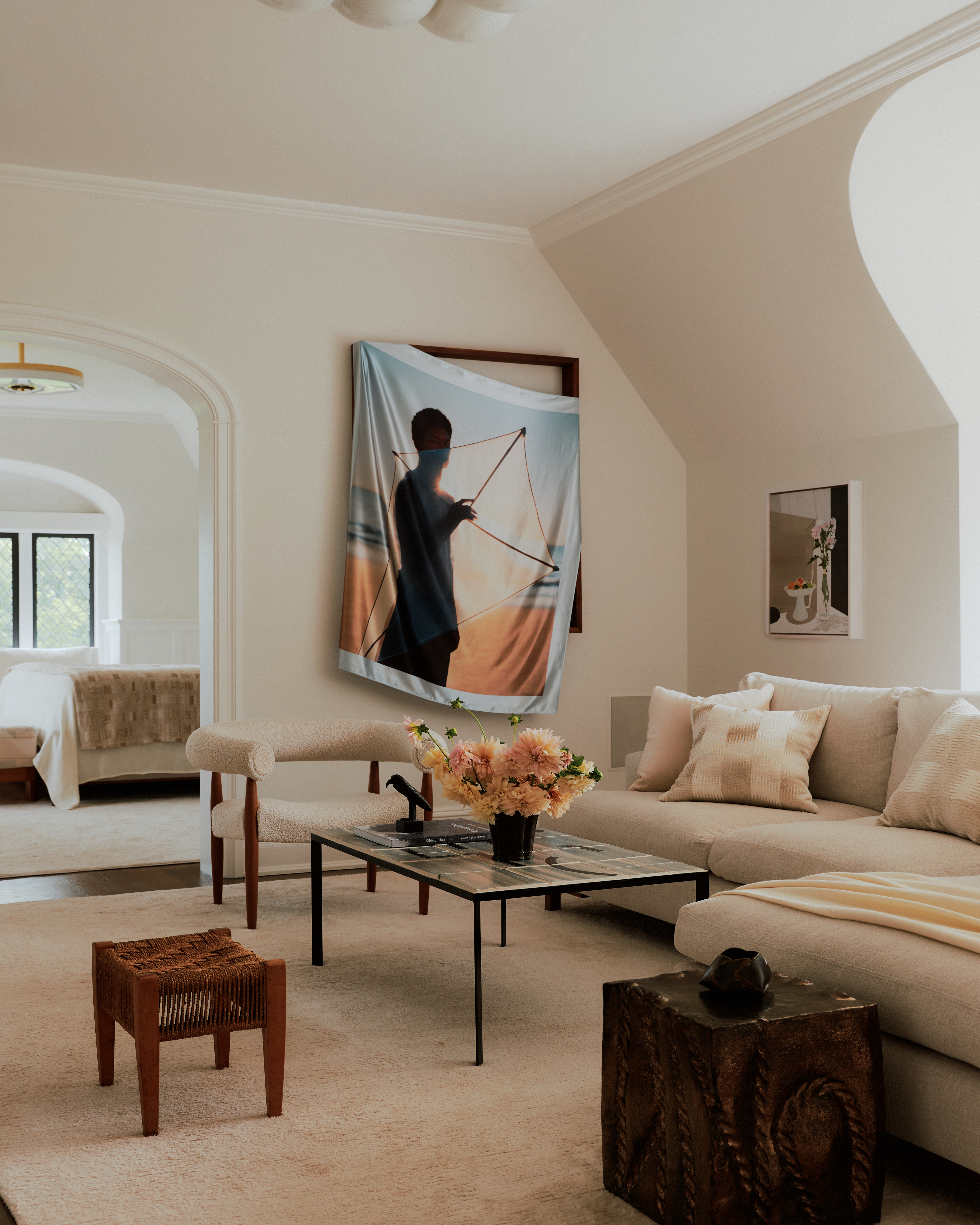 Sun-lit interior of a palatial residence wooden windows, white-washed walls, and artful decor.