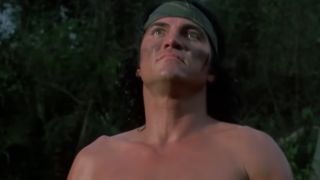 Sonny Landham with a green headband and face paint on in Predator