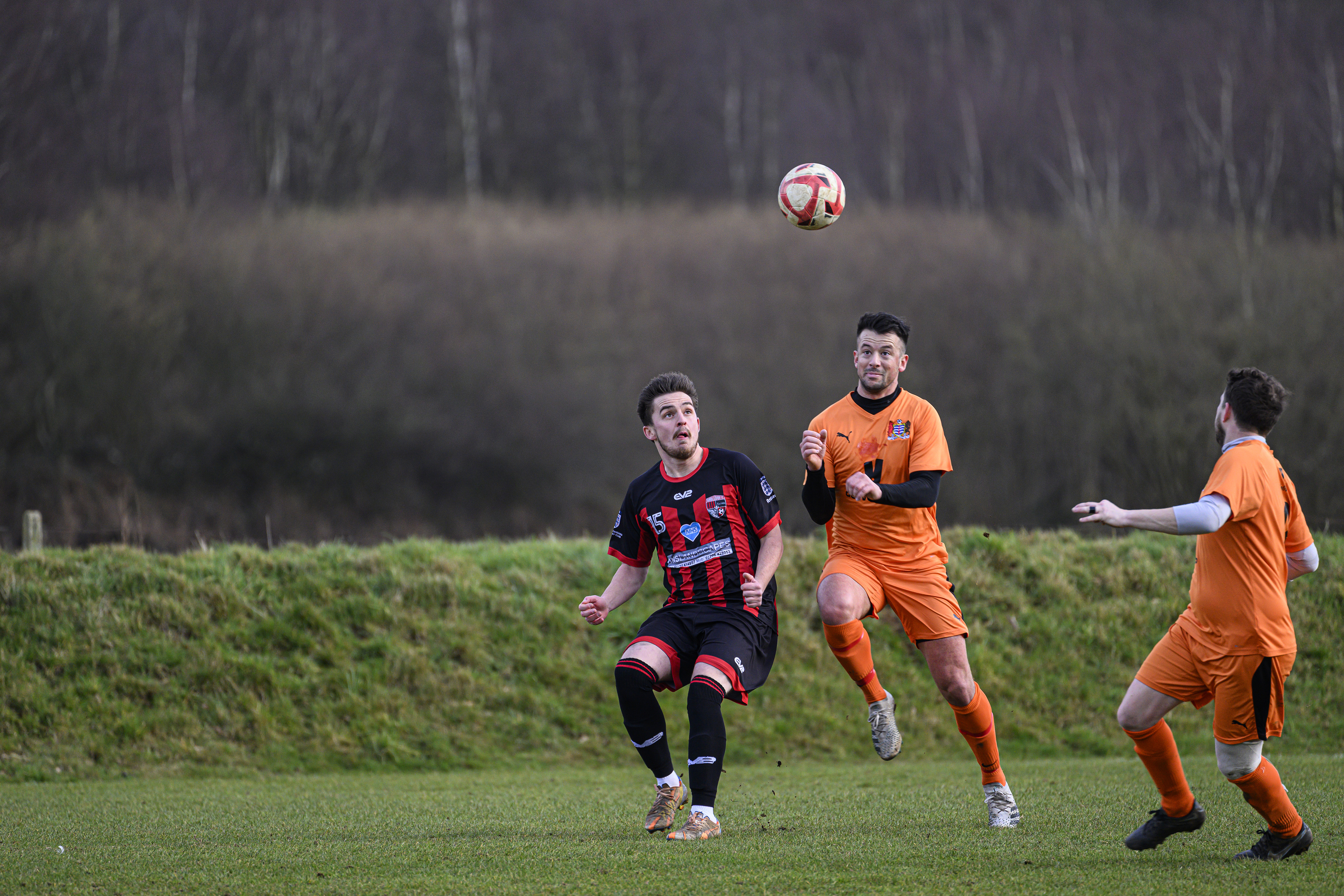 Some footballers playing in a field