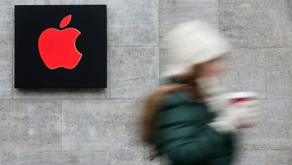 A pedestrian walks past an Apple store in Ireland