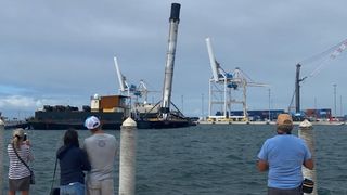A SpaceX Falcon 9 booster returns to shore with a lean, on Nov. 19, 2020.