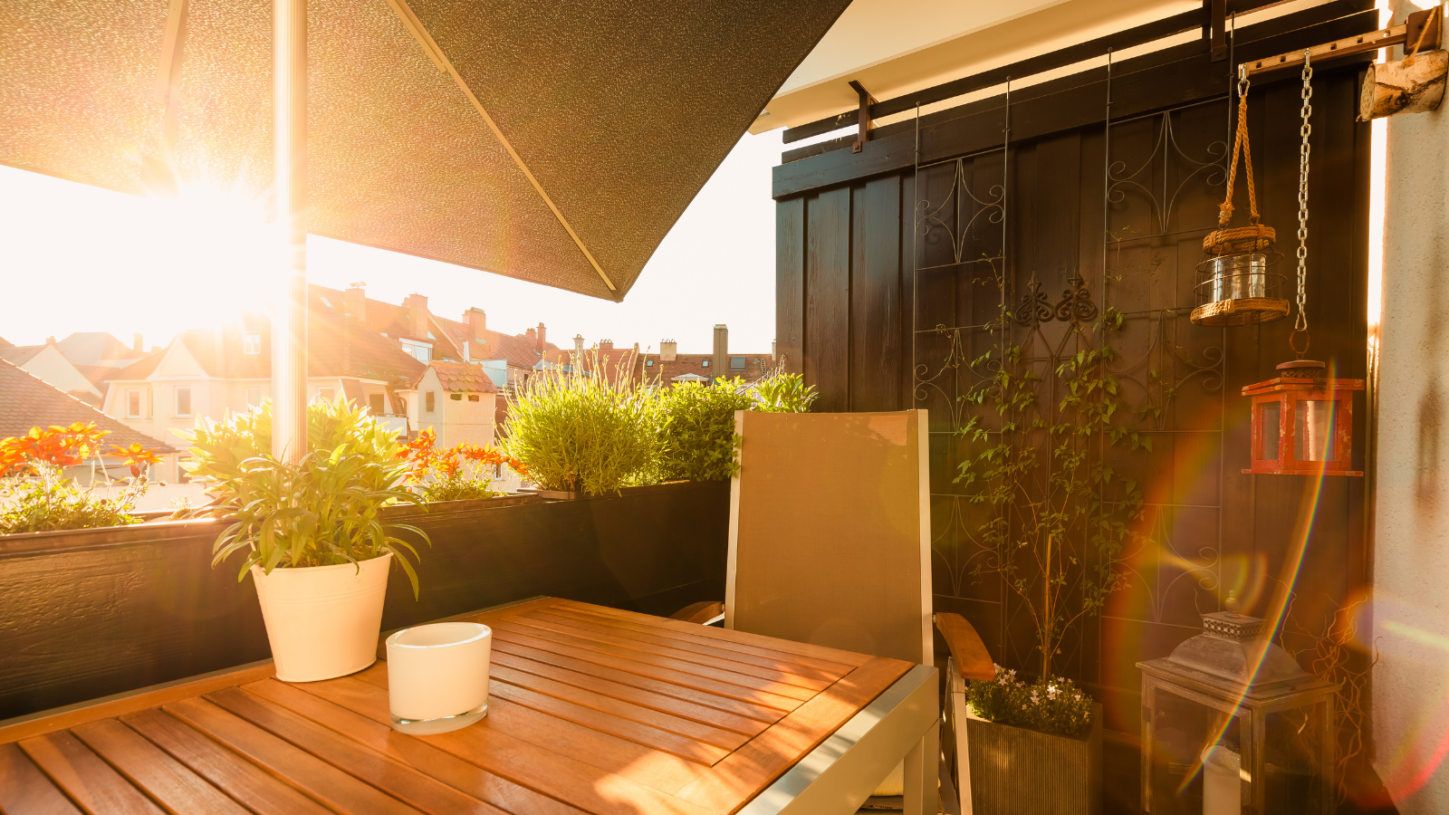 Small balcony with plants and sunshade in urban area