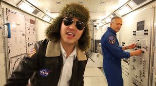 Astronaut Mike Massimino looks on as a student sings "NASA Johnson Style" in a video published on December 14.