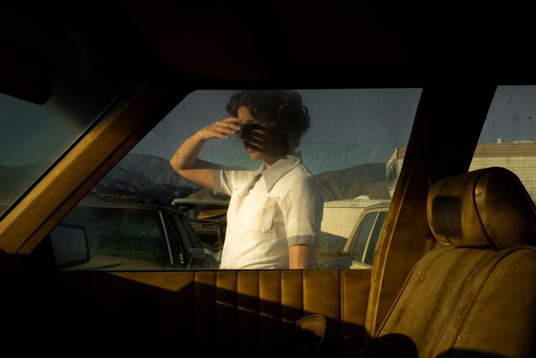 woman in front of a car window