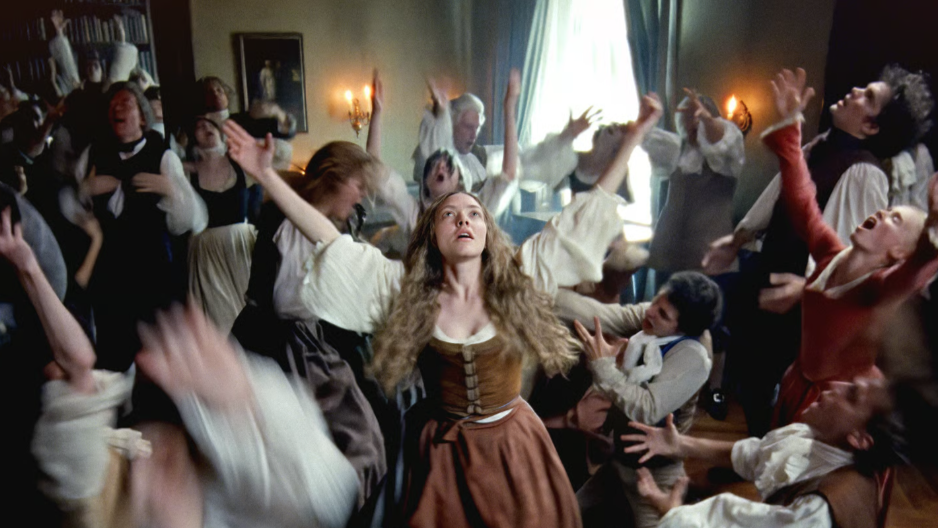 The Testament of Ann Lee still. The ensemble dance around wildly, with Ann Lee at the centre of the image