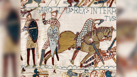 A colorful embroidered scene from the Bayeux Tapestry depicts the death of King Harold