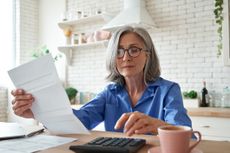 a woman budgeting in her kitchen