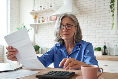 a woman budgeting in her kitchen